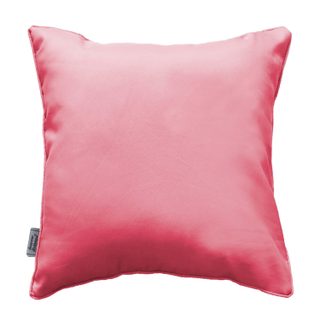 Coussin uni passepoil corail design et moderne